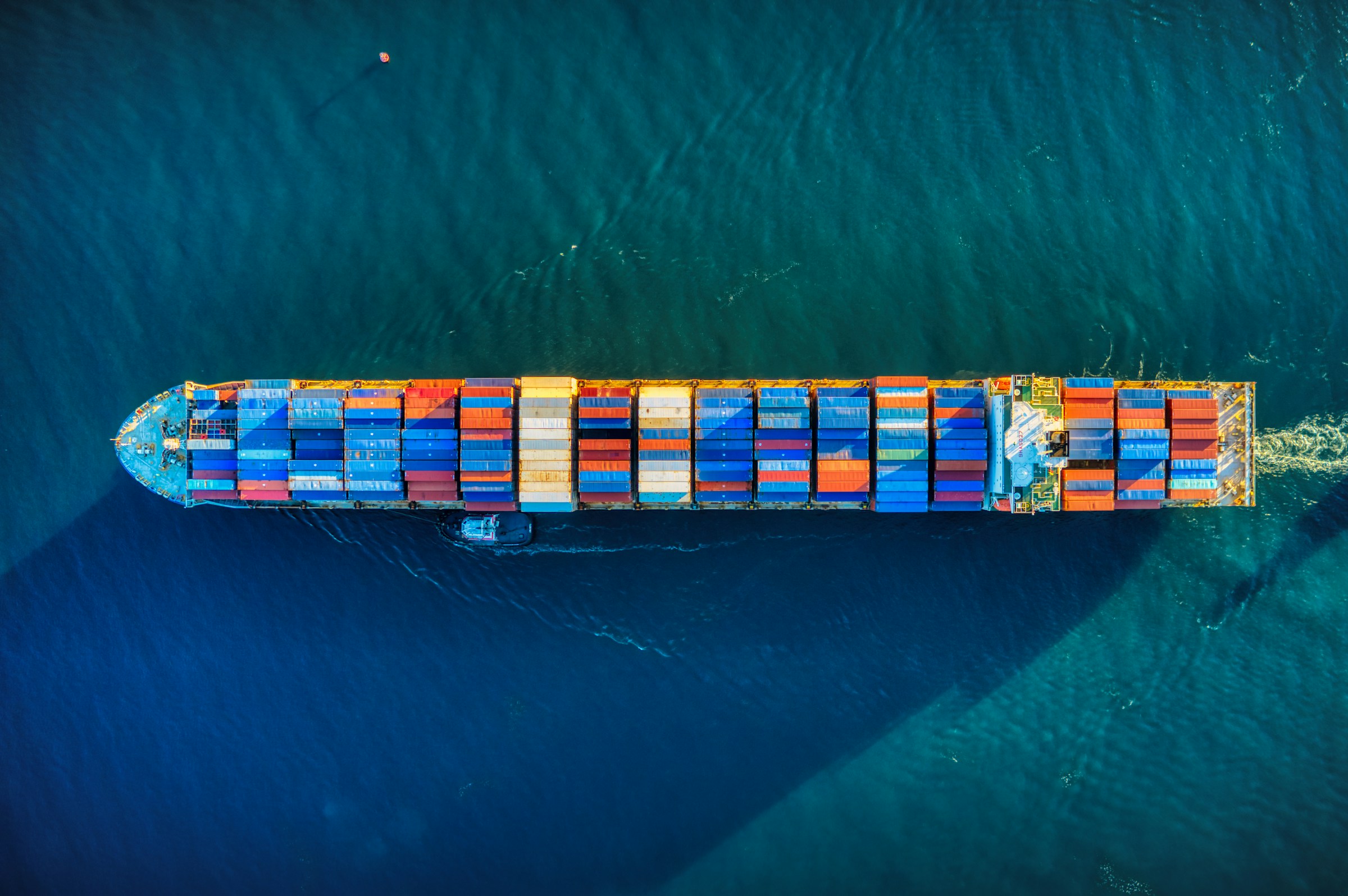 A container ship transporting cargo across blue water